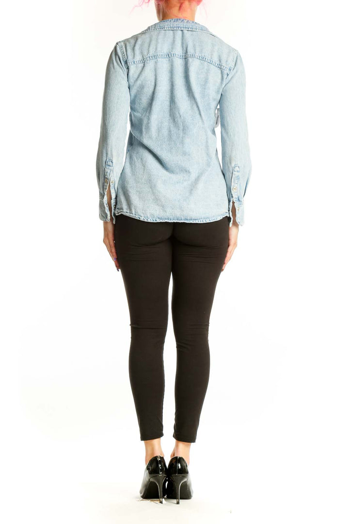 Light blue Mango denim button-up shirt back view showing relaxed fit and button details