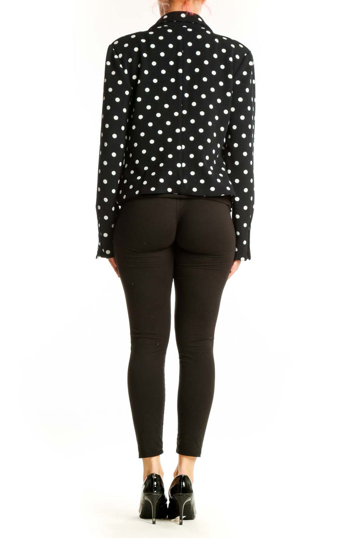 Black polka dot blazer with white dots, cropped fit, back view on model