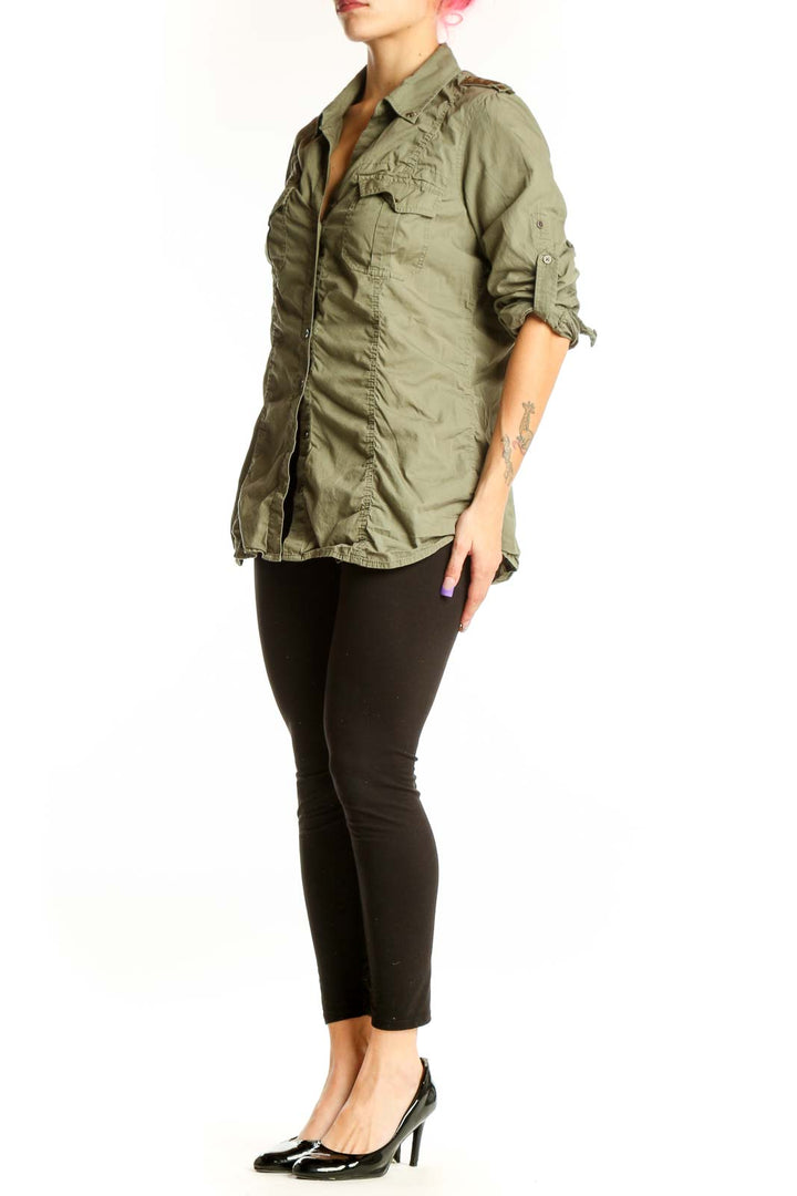 Sage green cotton military shirt by Express with dual chest pockets and button-up front, worn with black leggings