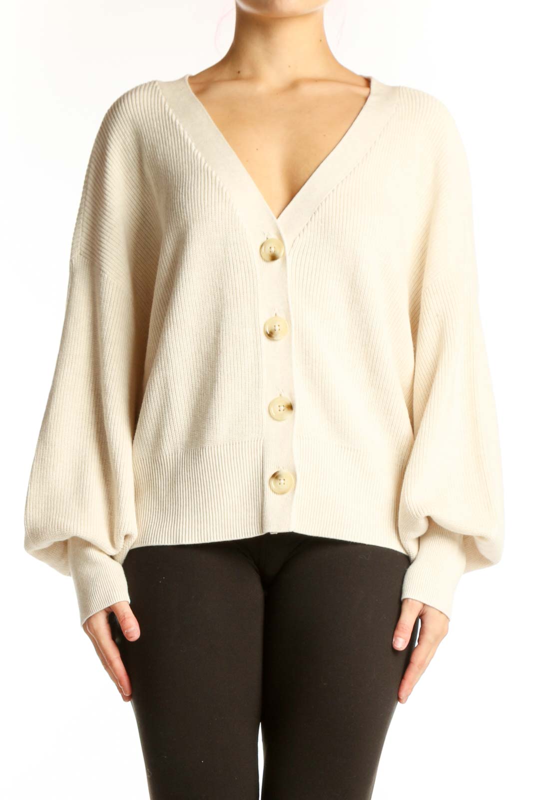 Cream ribbed button-front cardigan with puffed sleeves and gold buttons, worn with black pants
