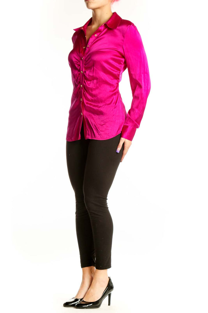 Front view of magenta silk ruched button-up blouse by Cache with gold-tone buttons and collared neckline