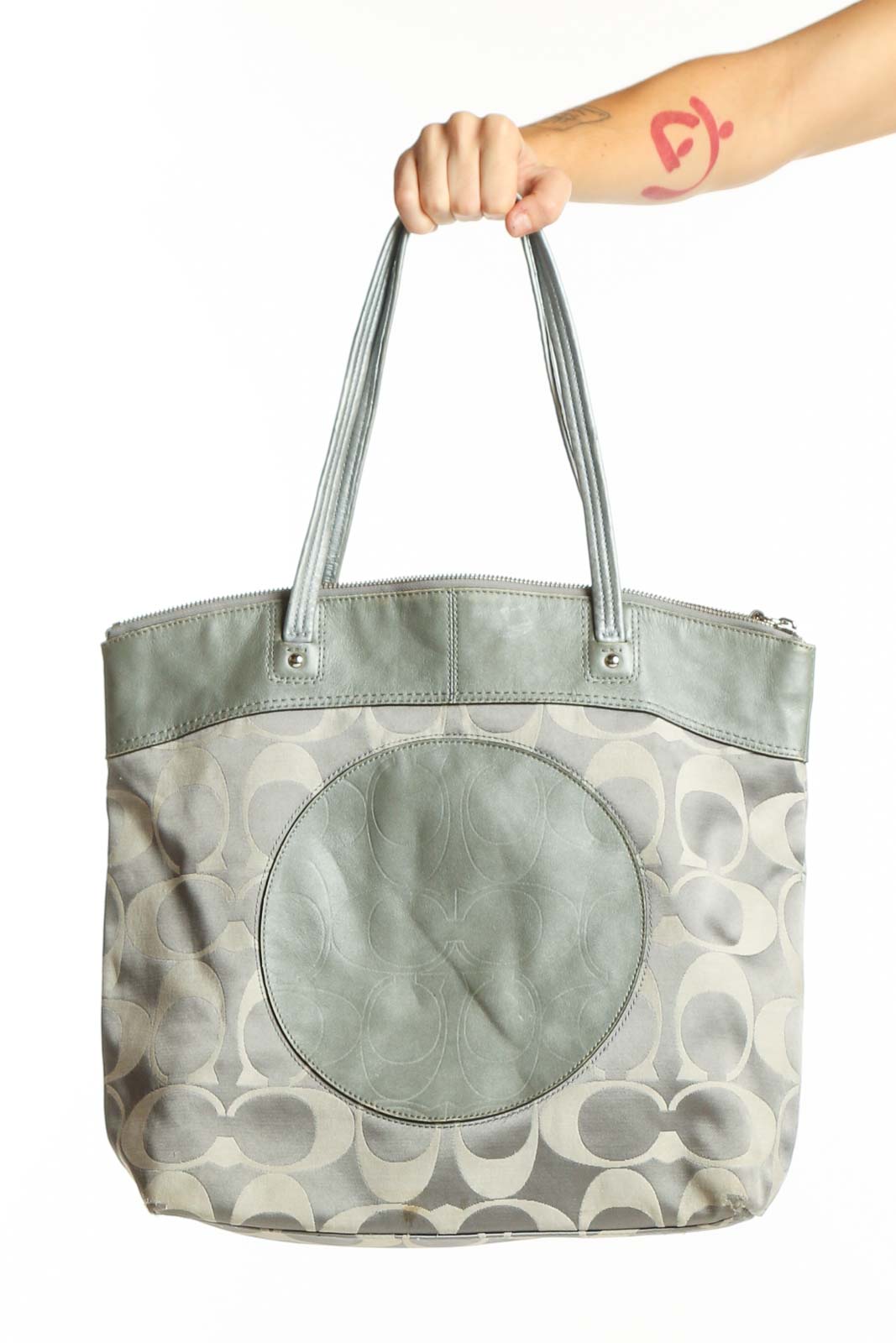 Cream Coach Signature Monogram Tote Bag with sage green leather handles and circular medallion detail, front view