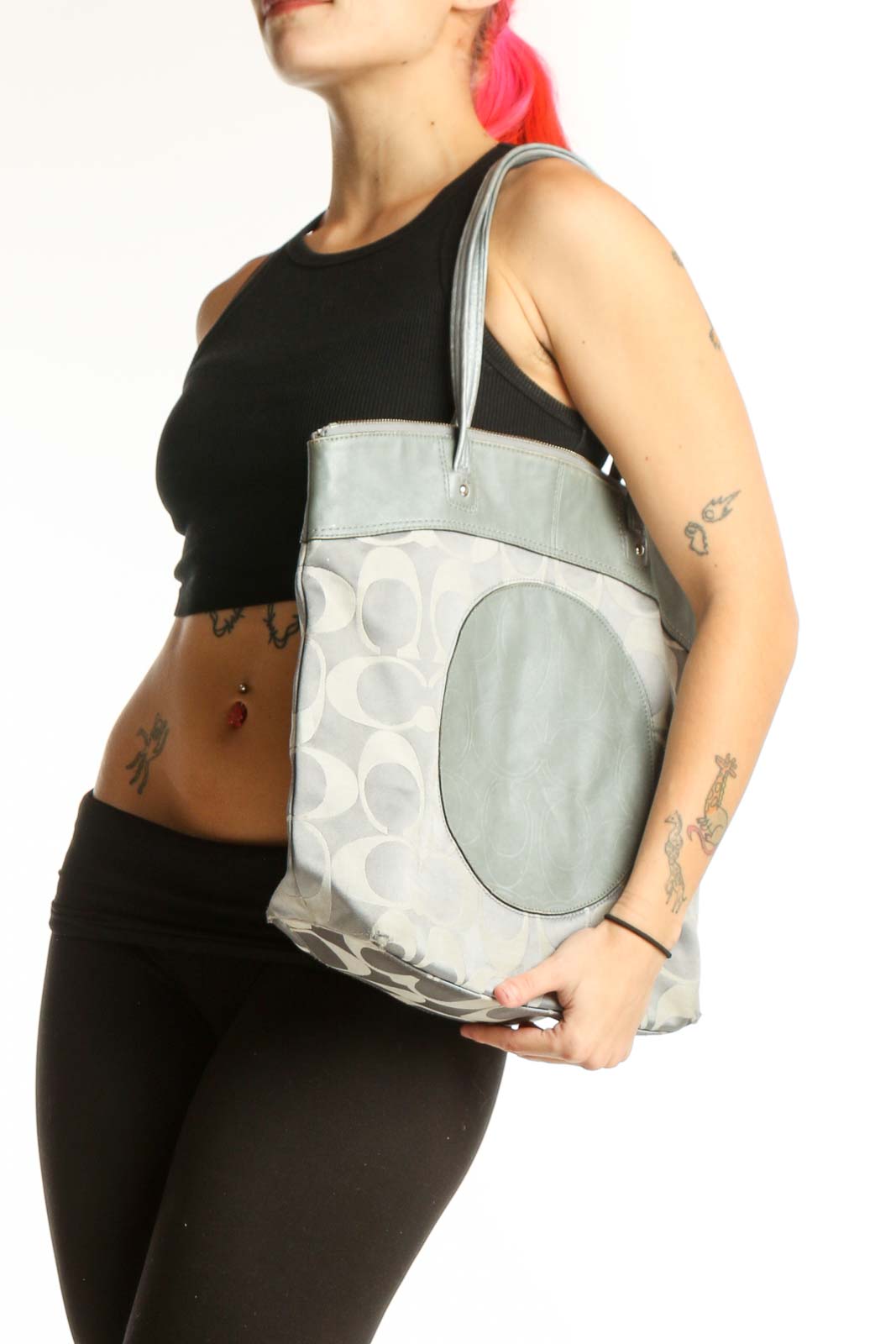 Cream Coach Signature Monogram Tote Bag with sage green leather handles and circular medallion detail, front view