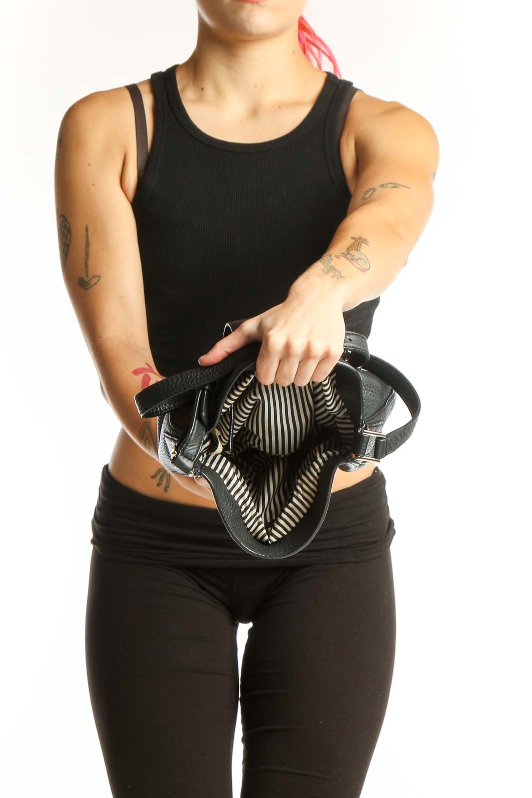 Back view of black leather Kate Spade crossbody bag worn across body, showing strap and structured design