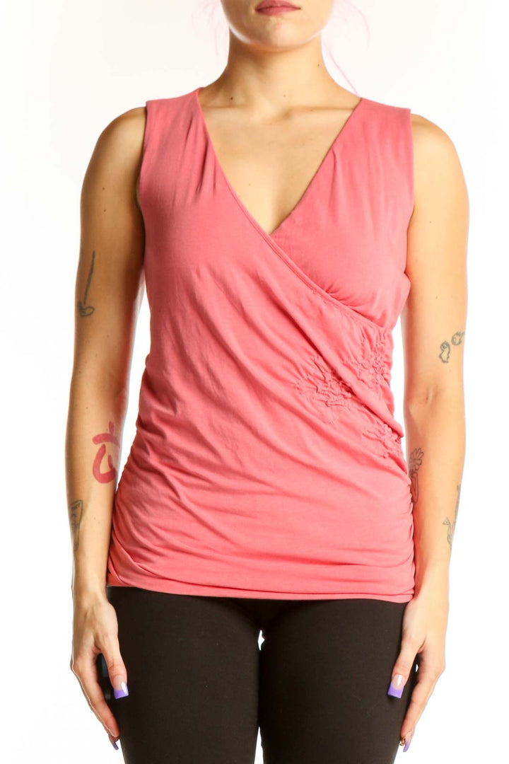 Pink wrap v-neck sleeveless top with side ruching, front view on model