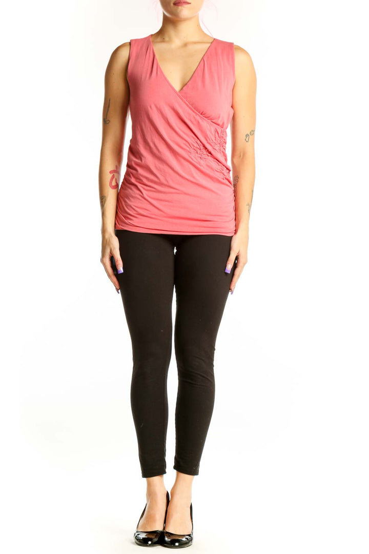 Pink wrap v-neck sleeveless top with side ruching, front view on model