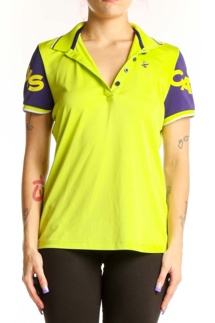 Front view of neon yellow polo shirt with purple sleeves and graphic detailing by Louis Castel