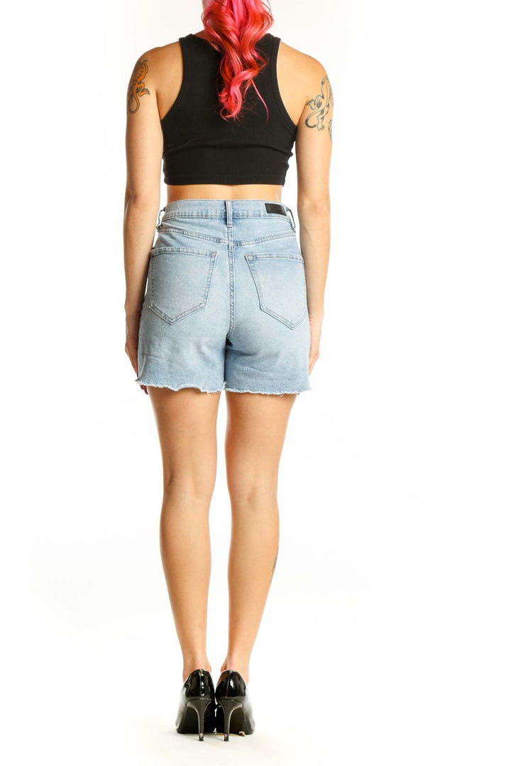 Light blue denim cut-off shorts with raw distressed hem, high-waisted fit, back view