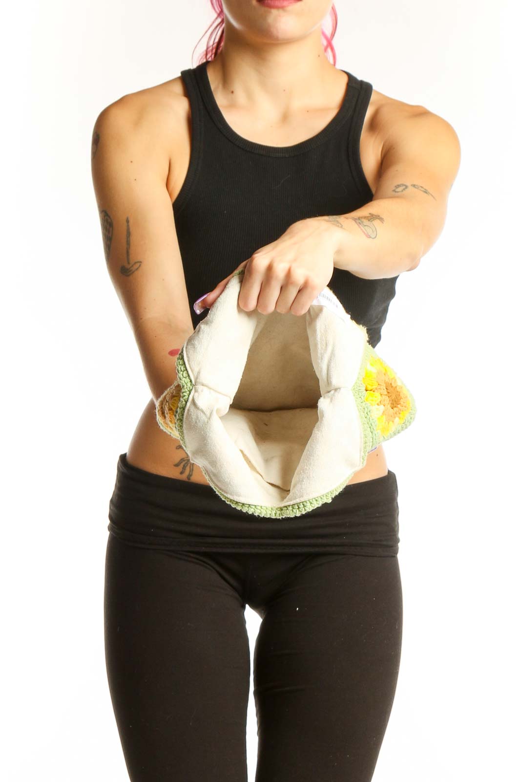 Back view of sage green sunflower crochet tote bag worn on shoulder, displaying full floral design