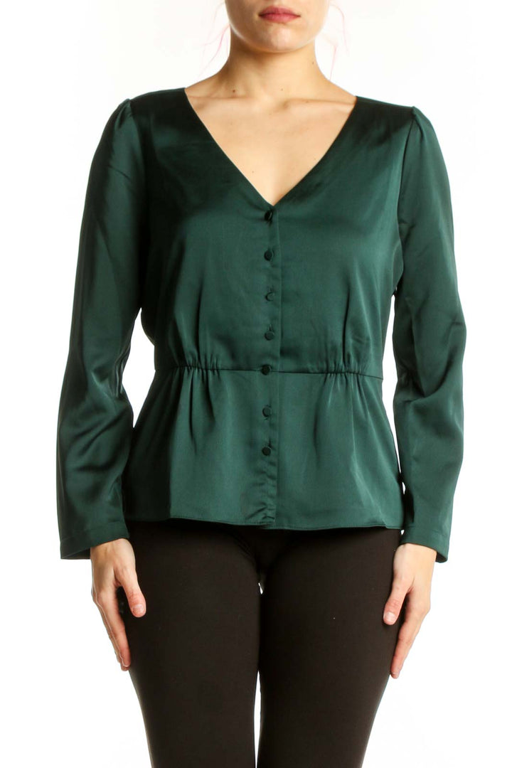 J.Crew green peplum top with V-neckline and button-front closure, worn with black pants