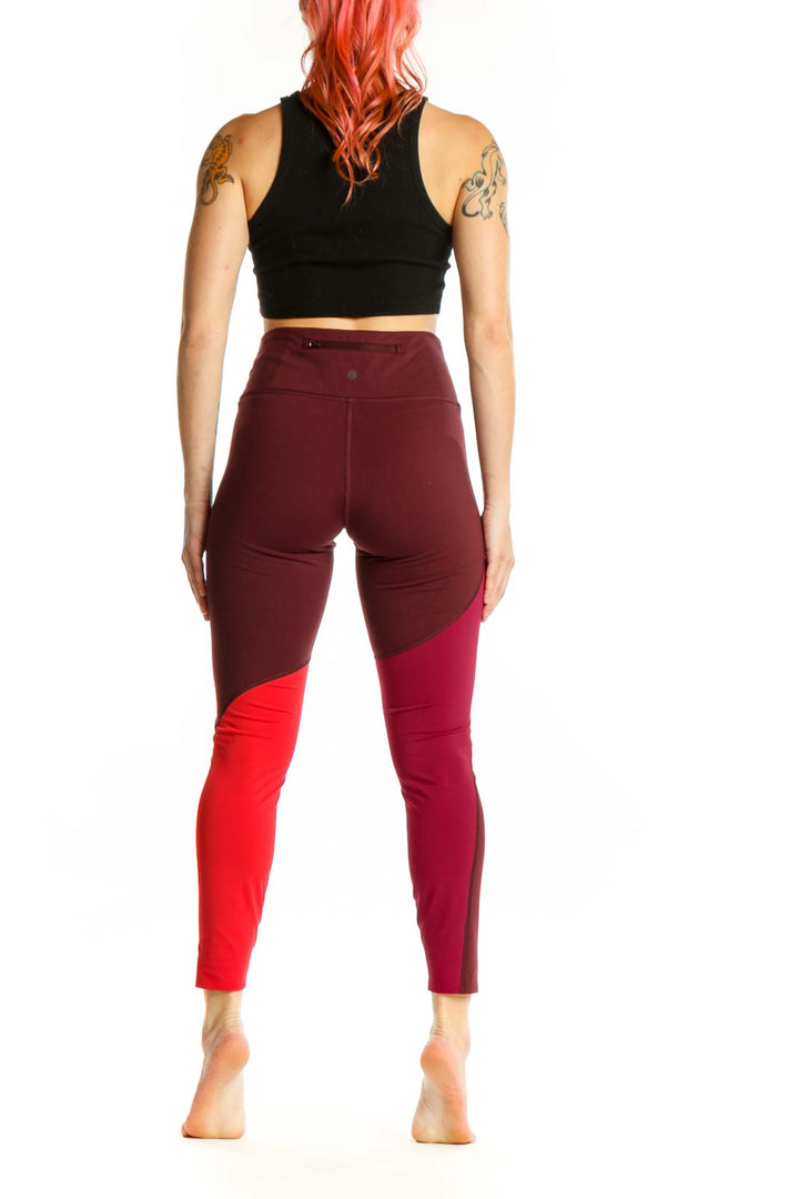 Burgundy and red colorblock cropped leggings back view, showing colorblock design and cropped ankle length