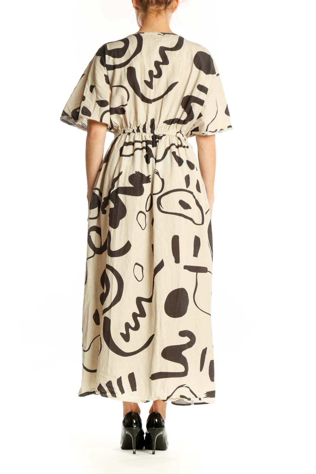 Cream and black abstract print midi dress with cinched waist and flowing skirt, back view