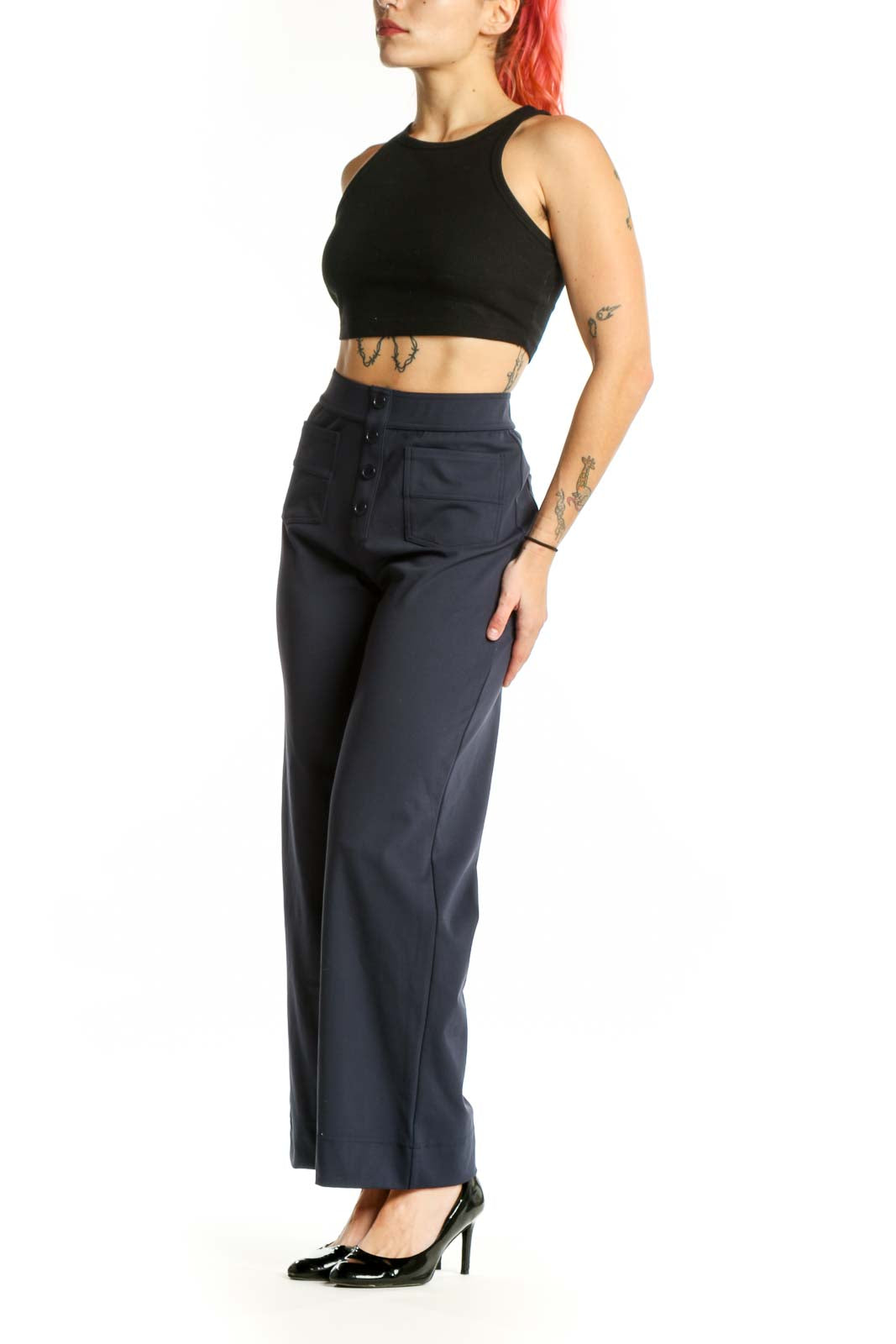 Navy high-waisted button-front pants with functional pockets, front view on model