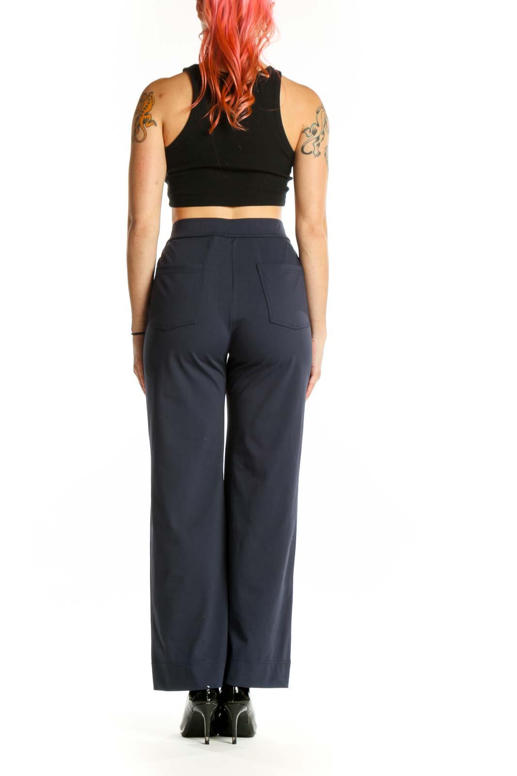 Navy high-waisted button-front pants, back view showing tailored fit and silhouette