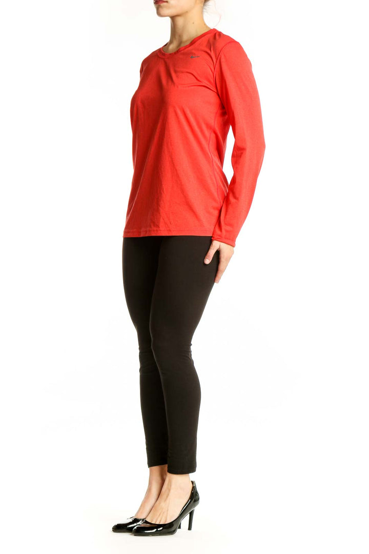 Red Nike long sleeve athletic top with crew neckline, front view on model