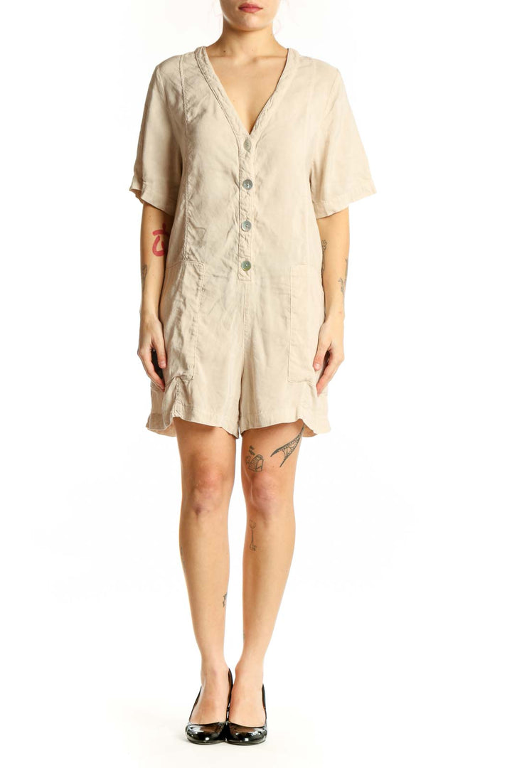 Cream button-front short sleeve romper with V-neckline and functional pockets, front view