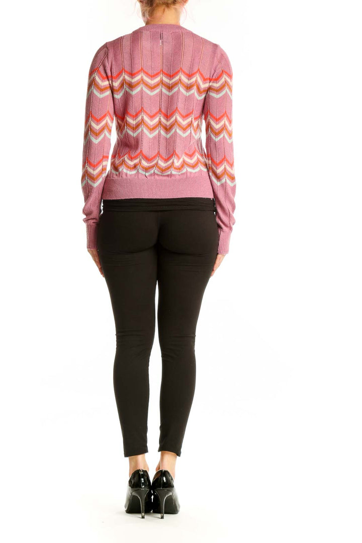 Back view of pink chevron stripe knit pullover showing full geometric pattern and cropped silhouette