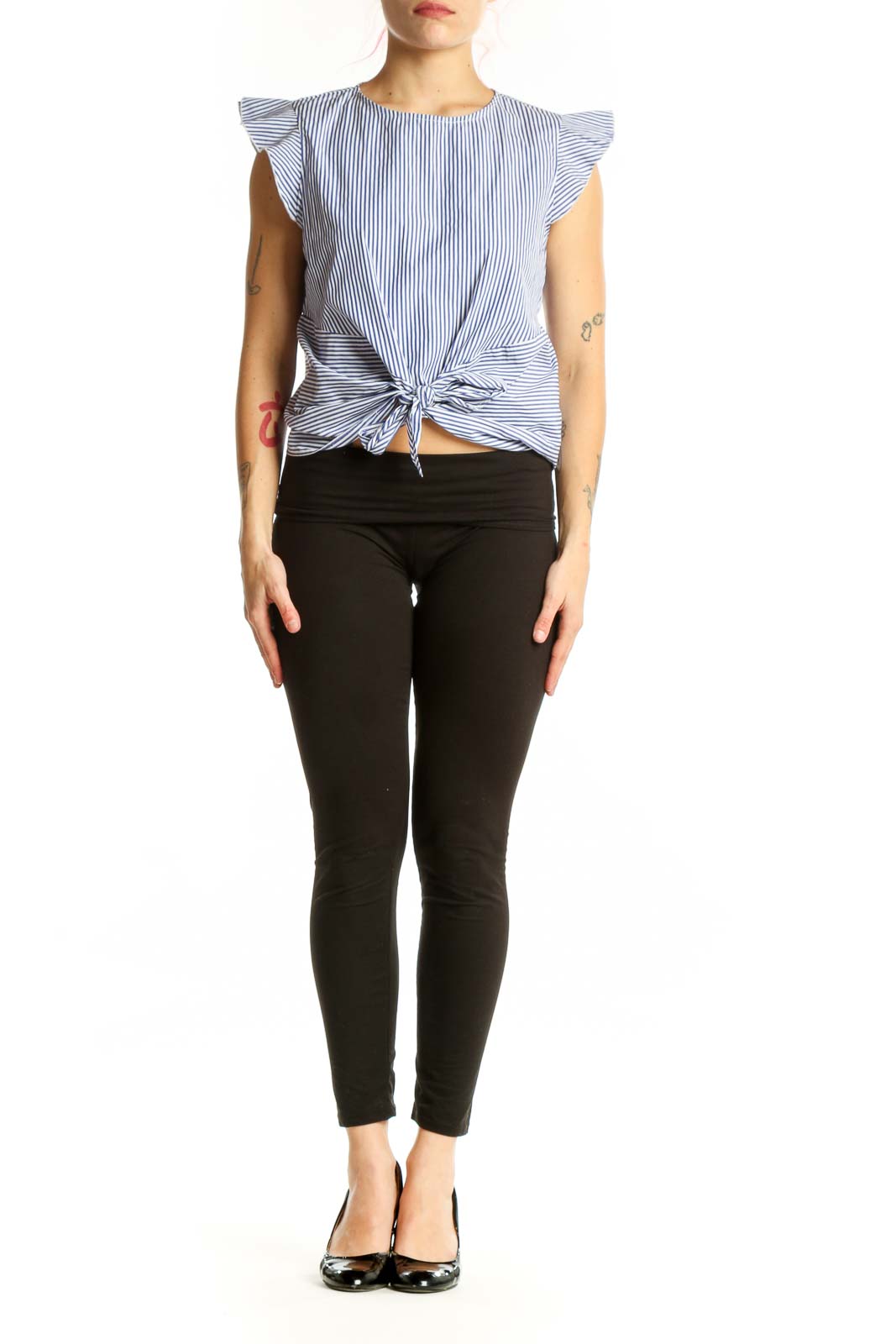 Blue and white striped Aqua top with ruffle sleeves and tie-front detail, worn with black pants