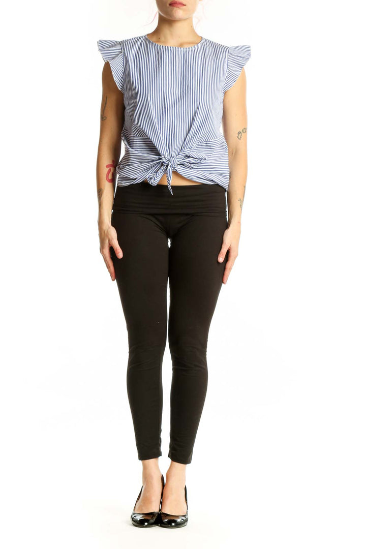 Blue and white striped Aqua top with ruffle sleeves and tie-front detail, worn with black pants