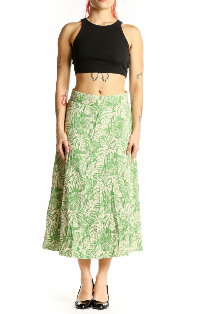 Green tropical leaf A-line midi skirt with cream background, front view showing flattering silhouette and botanical print pattern