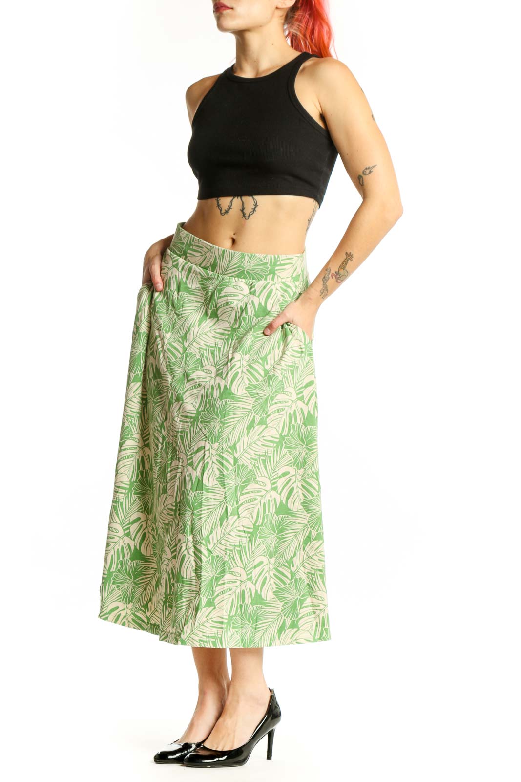 Green tropical leaf A-line midi skirt with cream background, front view showing flattering silhouette and botanical print pattern