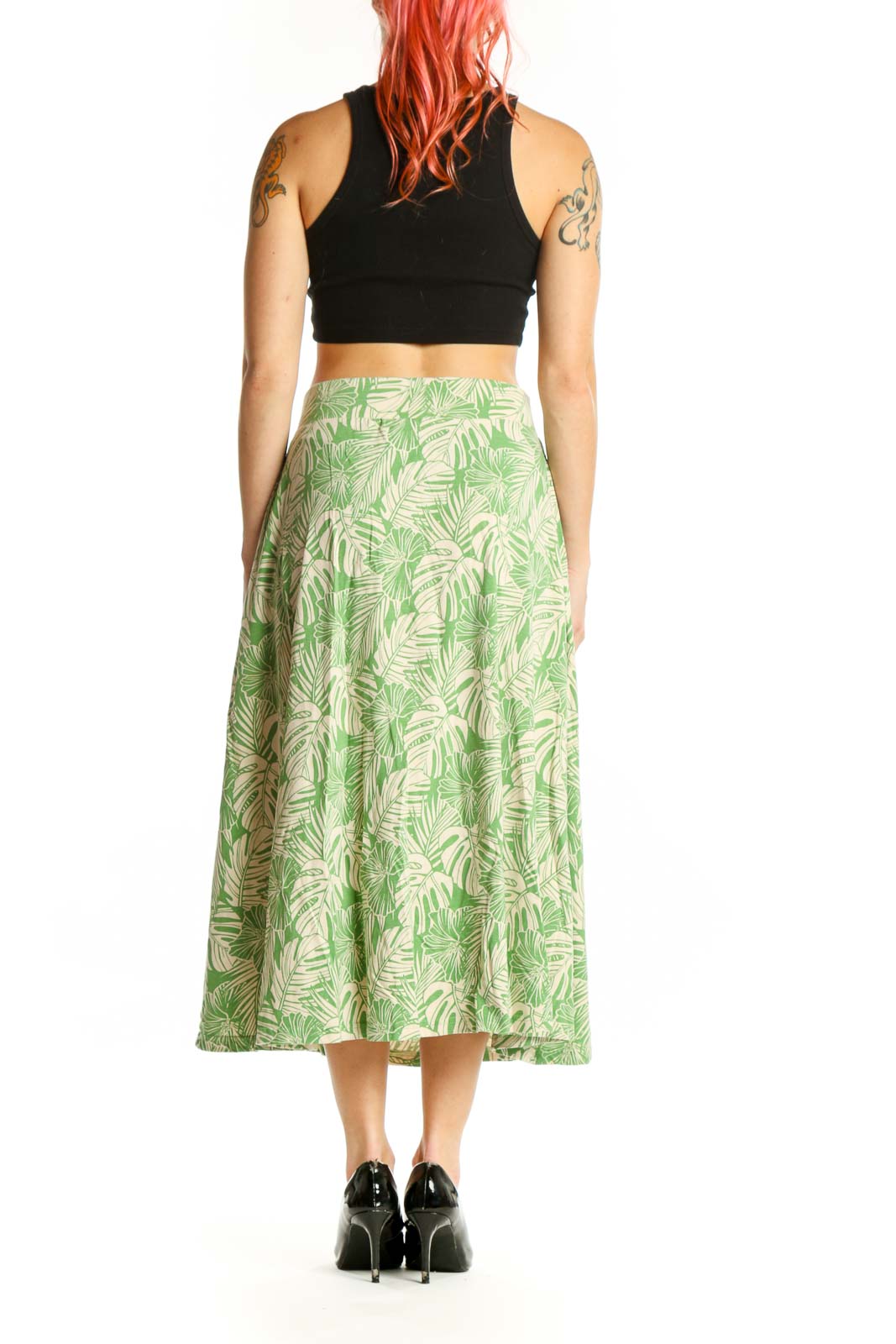Green tropical leaf A-line midi skirt back view displaying side pockets and full A-line cut with tropical leaf botanical print