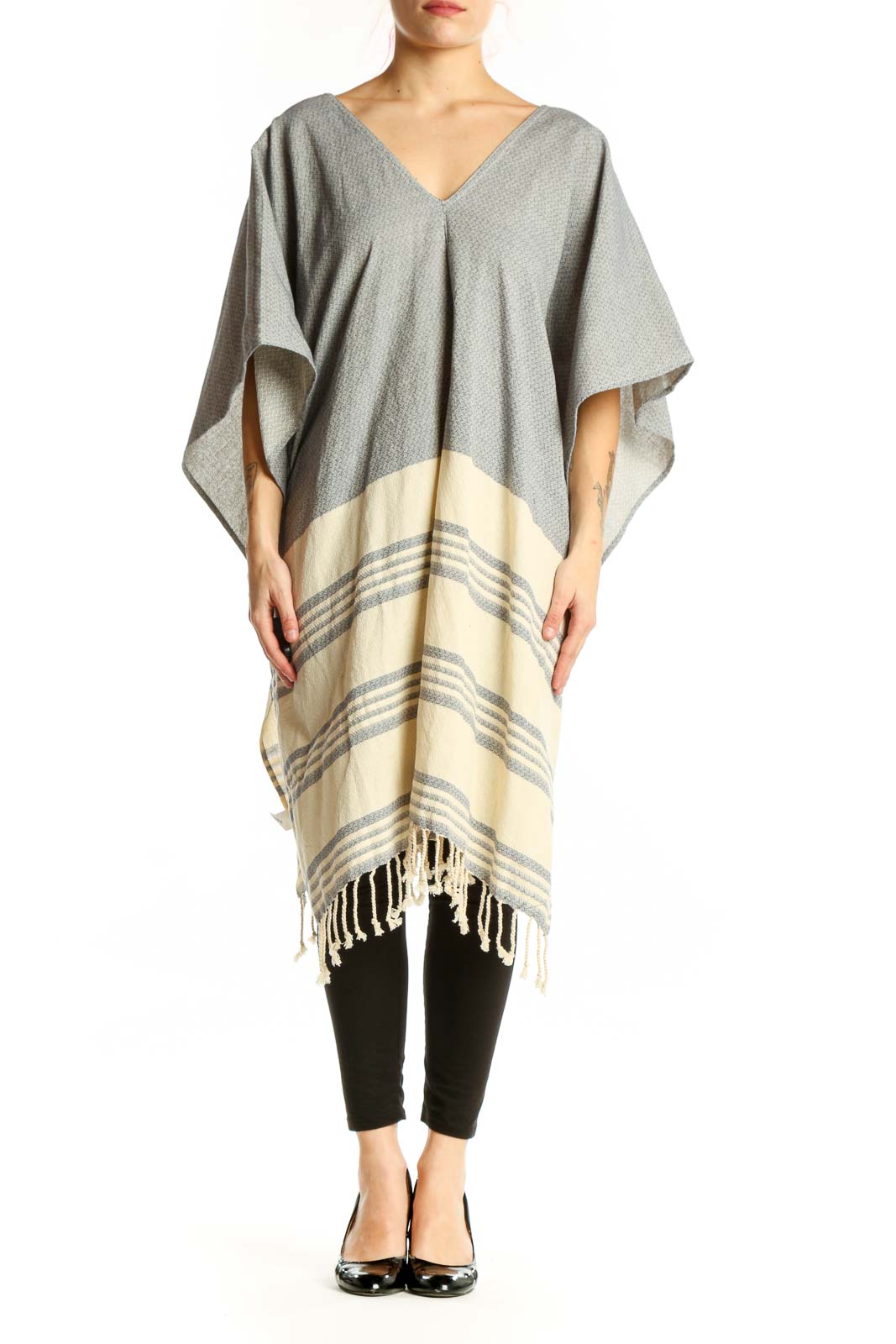 Gray cotton striped poncho knit with cream color-block design and tassel hem, front view