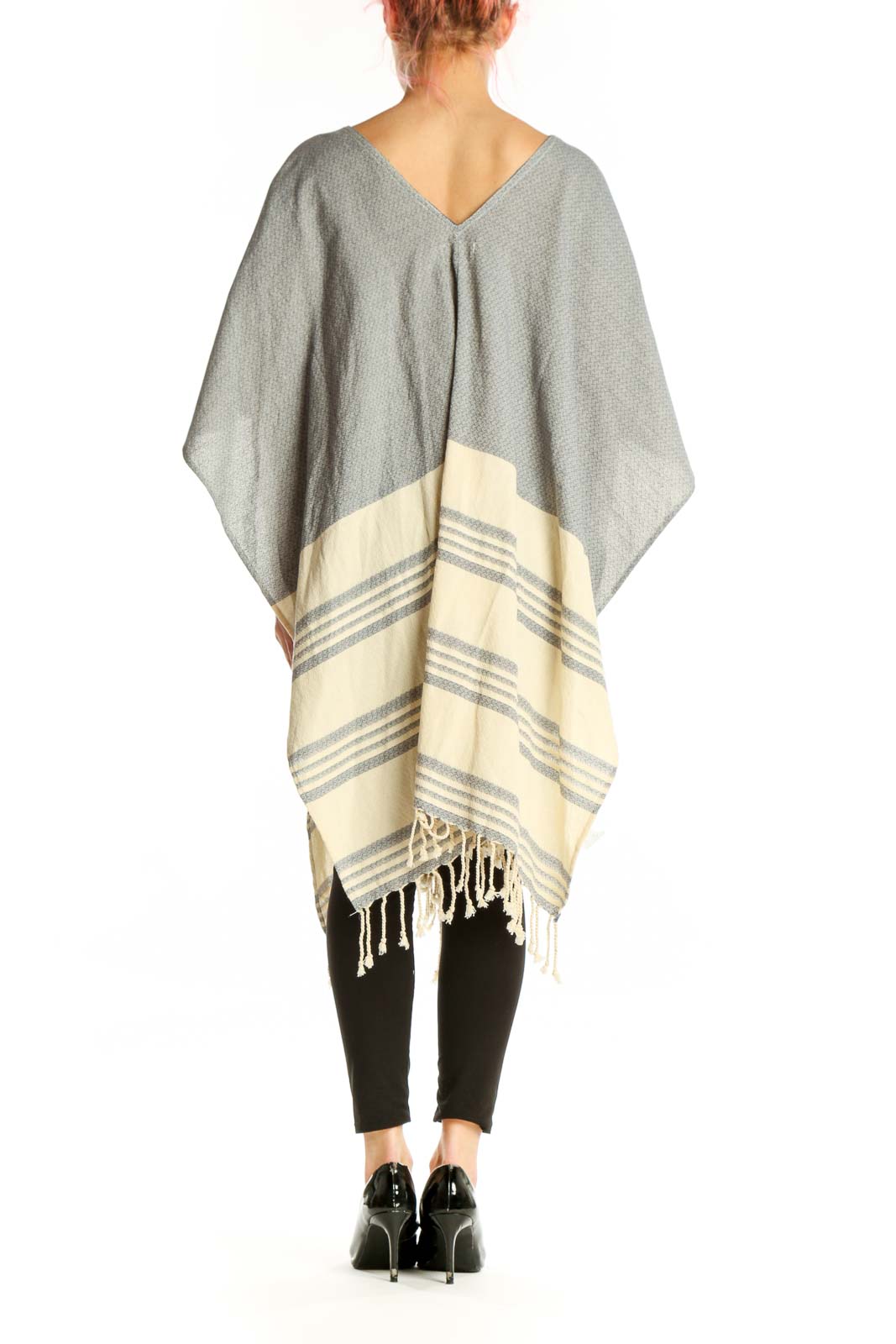 Gray cotton striped poncho knit with batwing sleeves and tassel detailing, back view