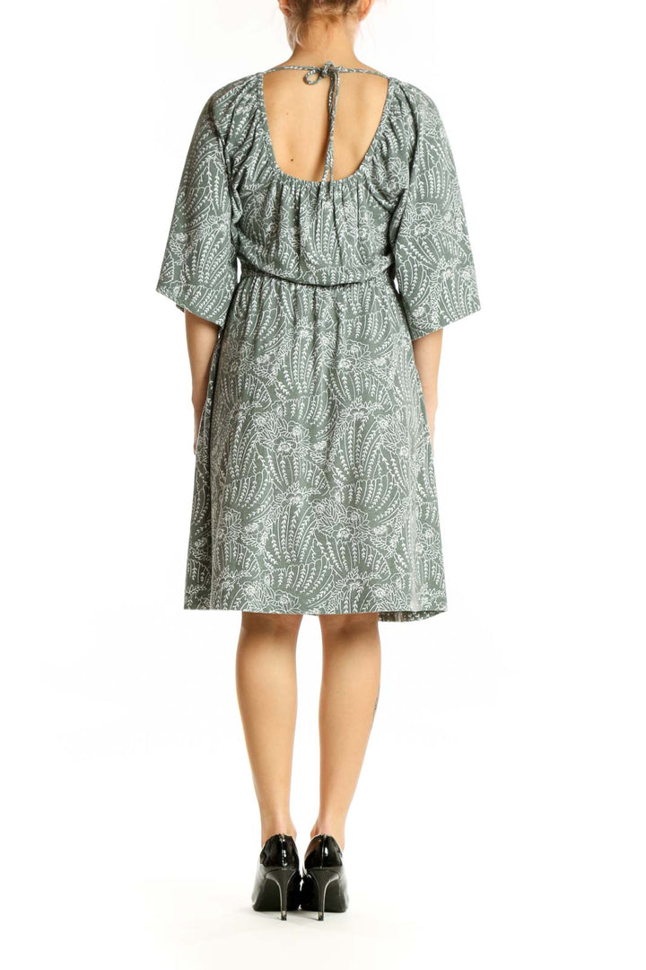 Green paisley print midi dress with flutter sleeves and A-line silhouette, back view