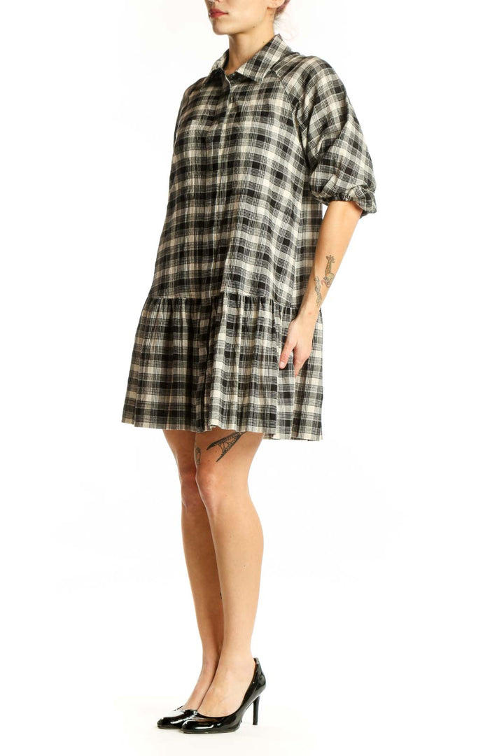 Black and white plaid button-down shirt dress with peplum hem, front view
