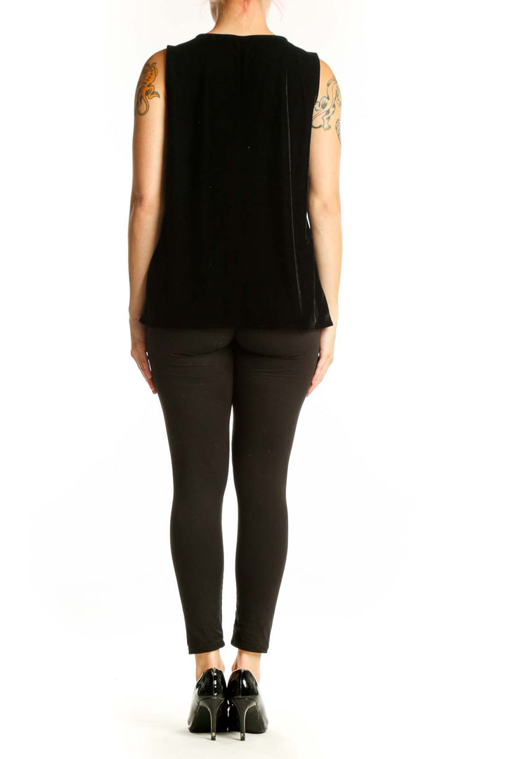 Black velvet sleeveless tank top with V-neckline, back view on model
