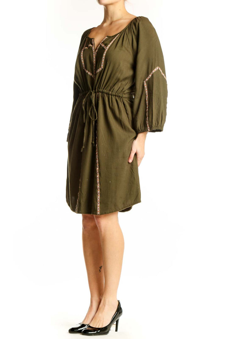 Olive green peasant dress with embroidered neckline and long sleeves, front view