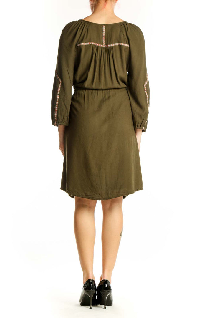 Olive green peasant dress with embroidered back detail and drawstring waist, back view