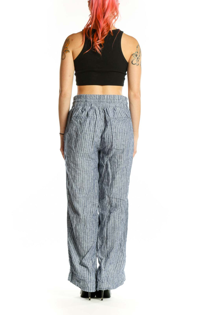 Gray pinstriped linen wide-leg pants with side pockets, back view