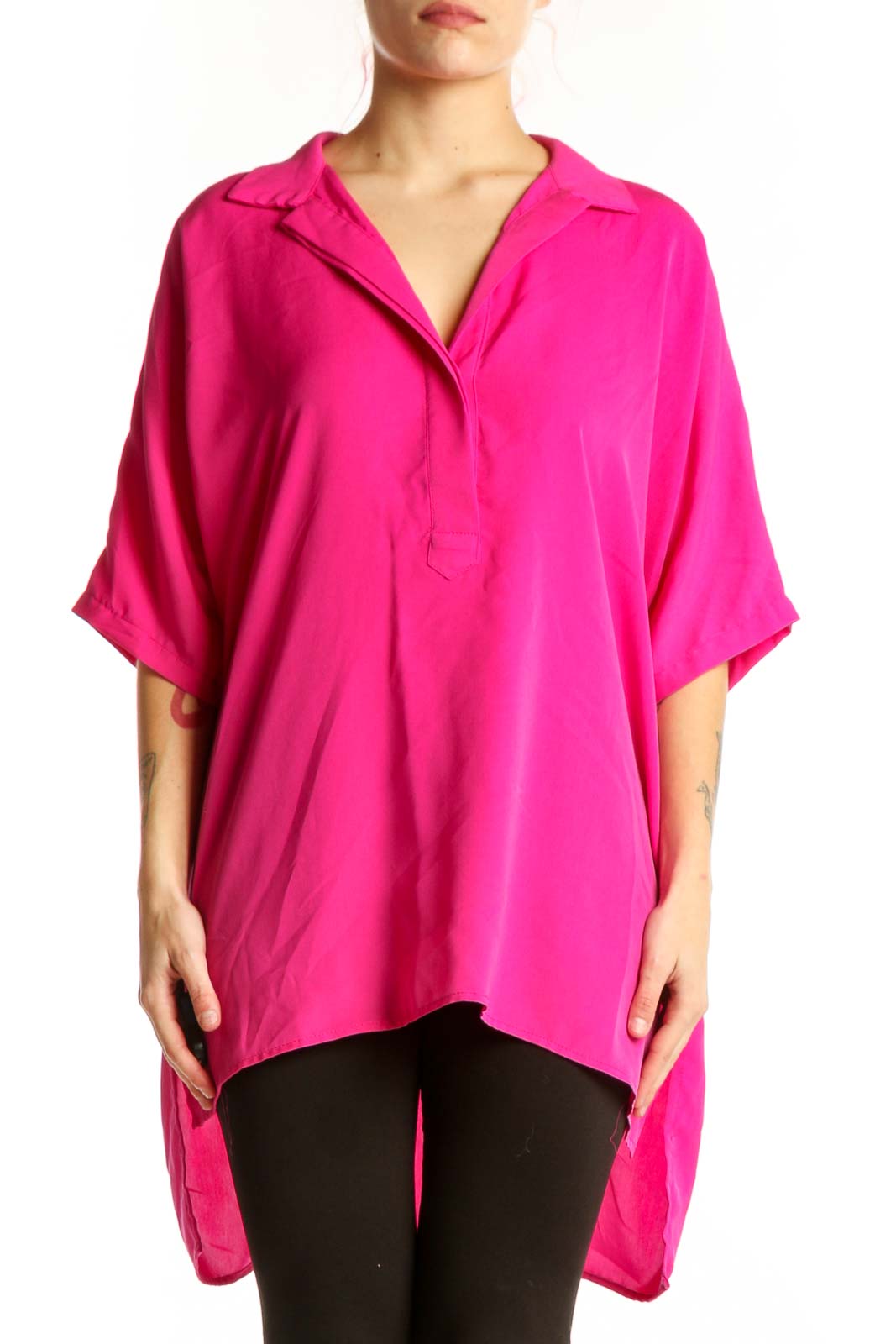 Front view of pink oversized button-up shirt with collar and rolled sleeves on model