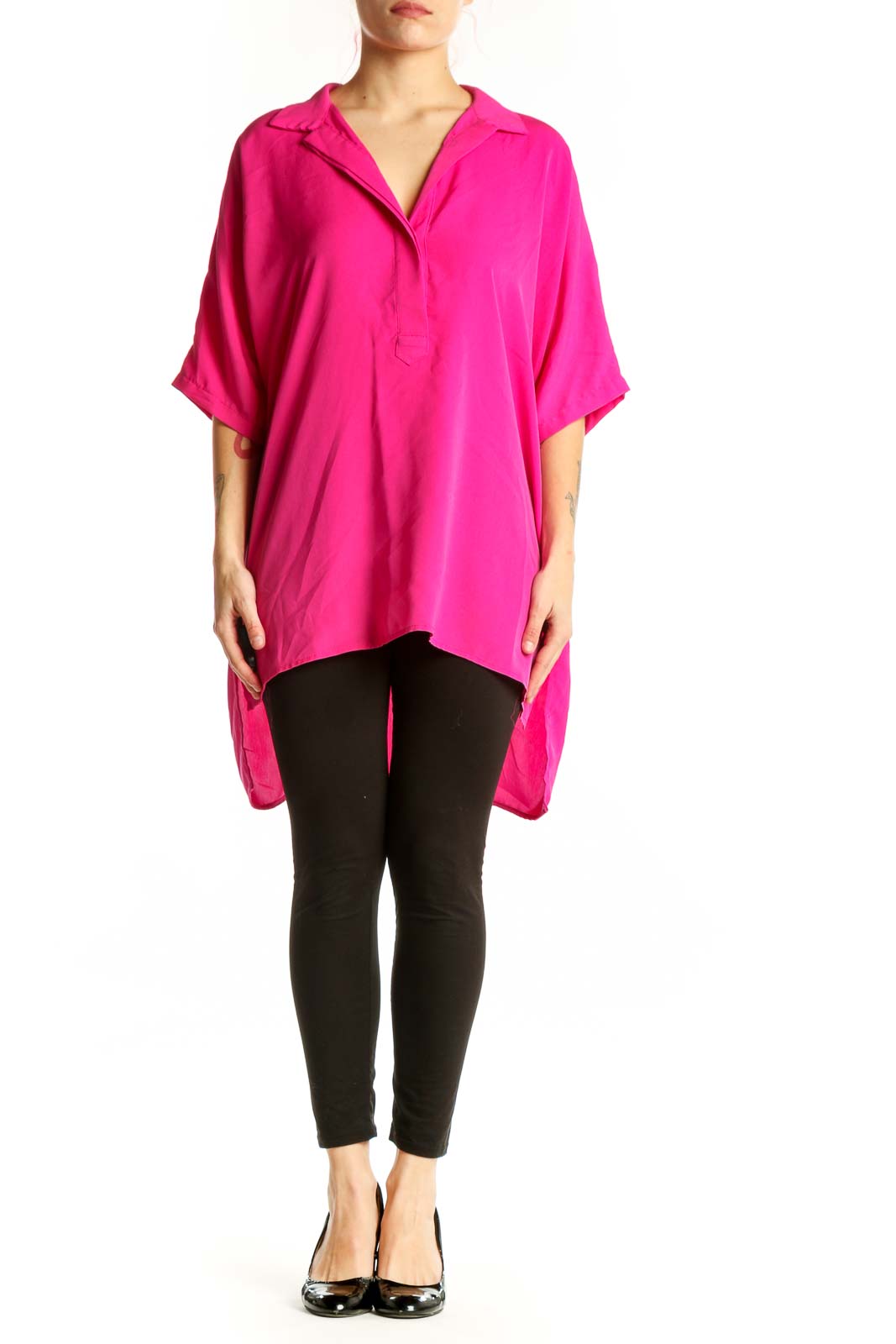 Front view of pink oversized button-up shirt with collar and rolled sleeves on model