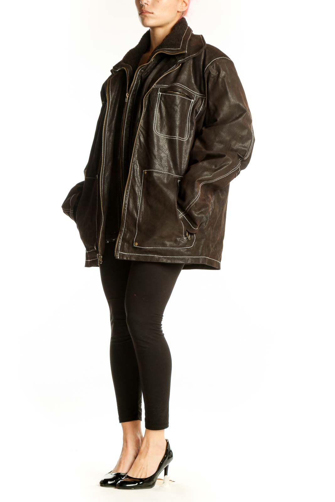 Black genuine leather jacket with cream contrast stitching, oversized fit, and zippered pockets worn by model
