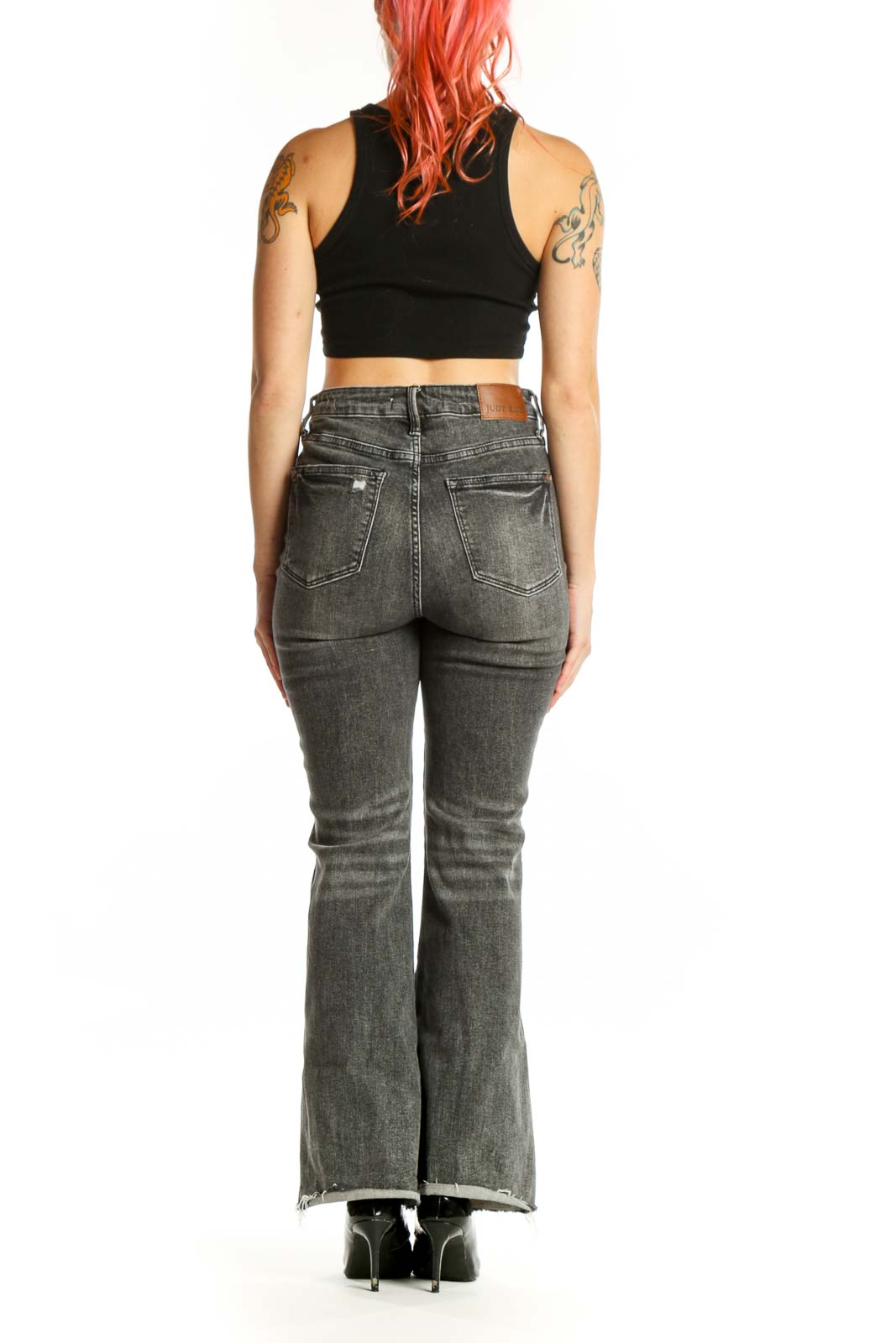 Back view of gray flare denim jeans by JUDY BLUE showing the flattering fit and flared leg silhouette