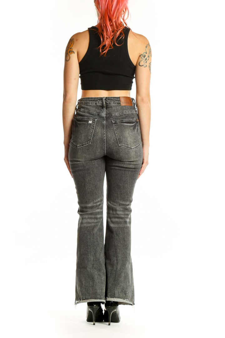 Back view of gray flare denim jeans by JUDY BLUE showing the flattering fit and flared leg silhouette