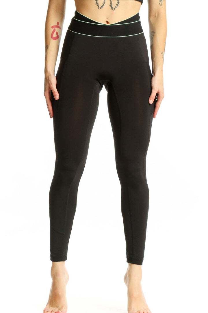 FP Movement black high-waisted nylon leggings with contrast piping, front view on model