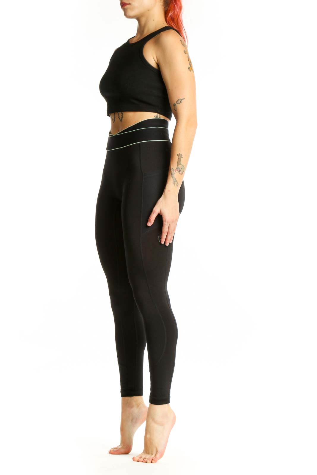 FP Movement black high-waisted nylon leggings with contrast piping, front view on model