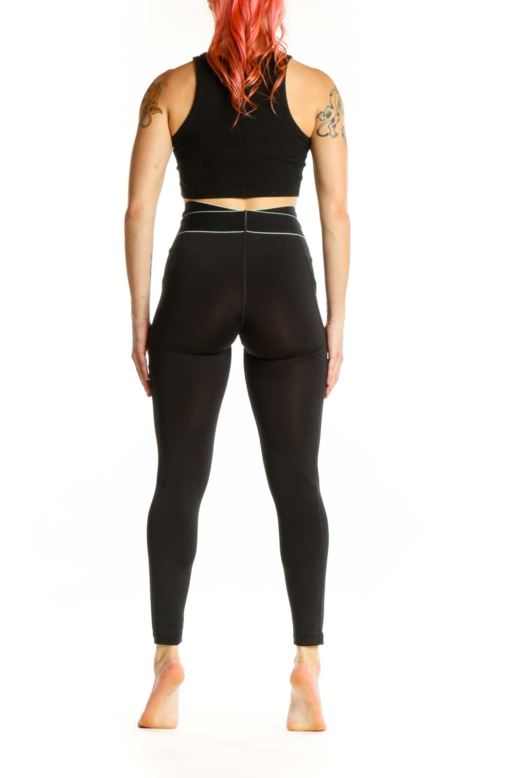 FP Movement black cropped activewear leggings with contrast waistband, back side view on model