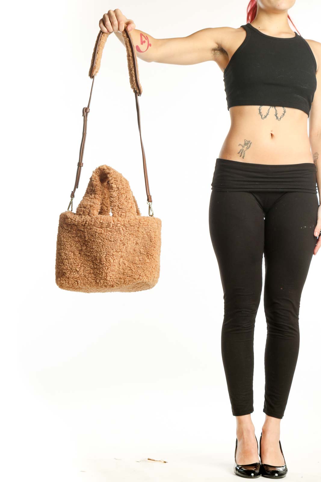 Beige teddy fleece satchel shoulder bag with leather straps held in hand, showing front view and texture