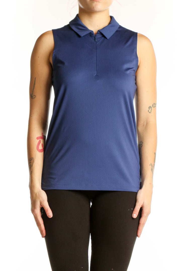 Navy sleeveless polo tank top with collared neckline and half-zip front closure, worn with black leggings