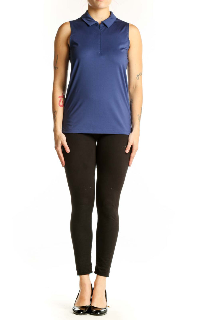 Navy sleeveless polo tank top with collared neckline and half-zip front closure, worn with black leggings