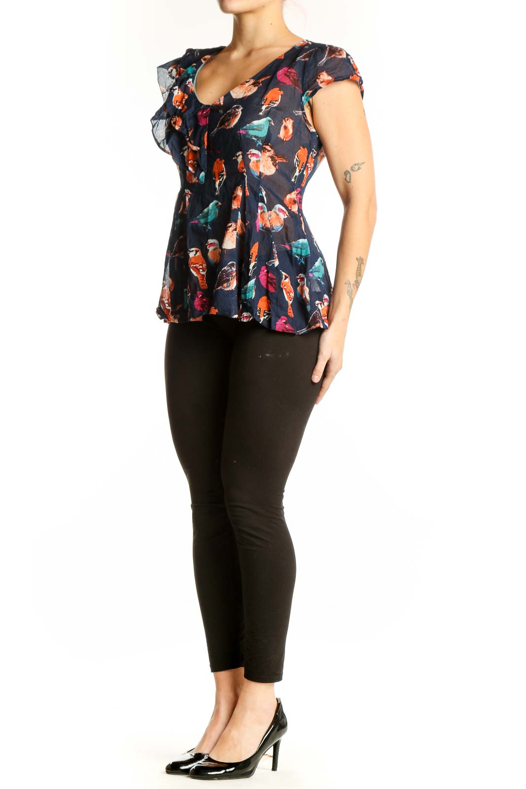 Navy floral cotton top with ruffle cap sleeves and peplum hem, featuring vibrant bird and botanical print