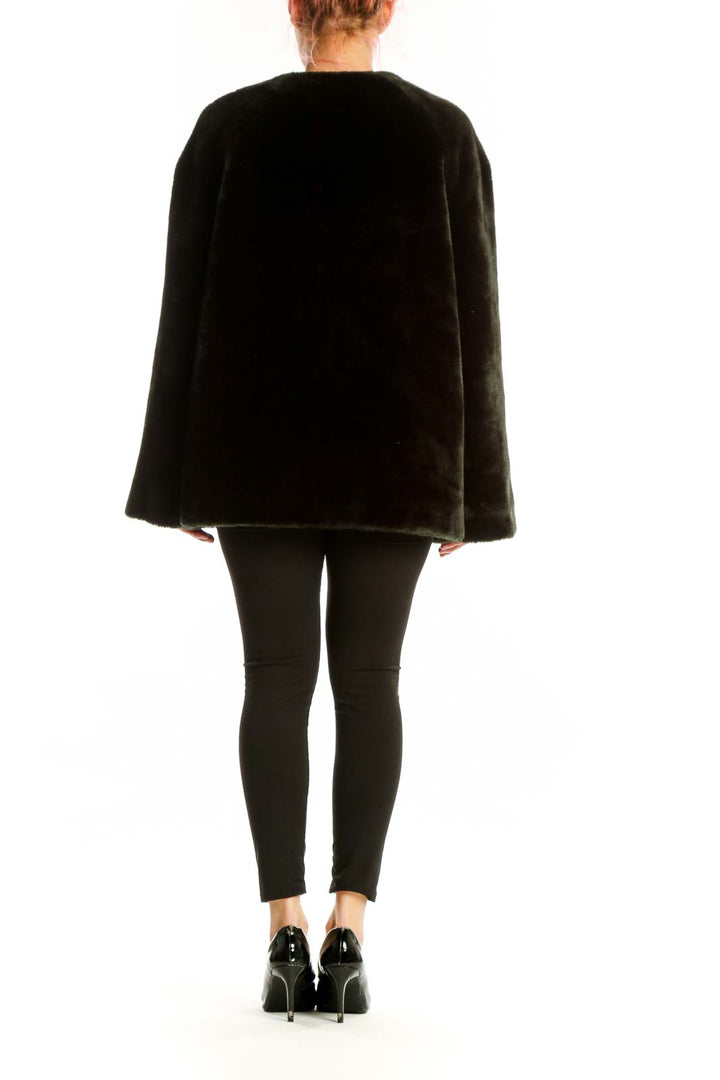 Back view of black velvet jacket showing button-front closure and draping design