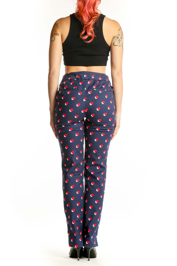 Navy Boden pants with red apple print, back view on model, size S