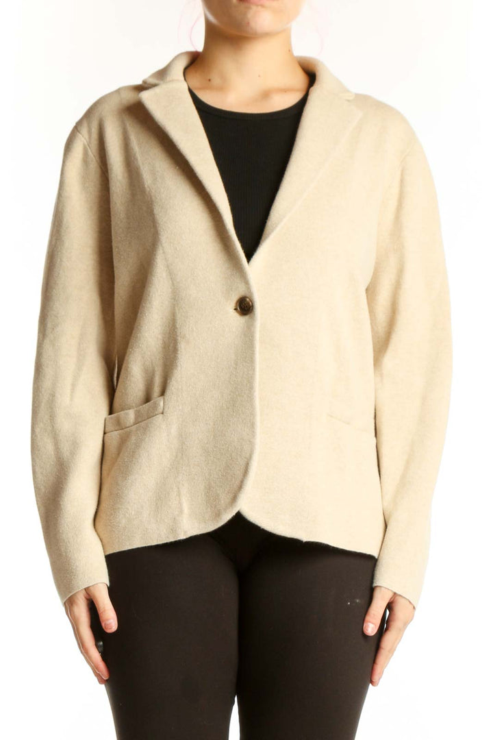 Front view of cream cotton knit blazer by J.Crew with single-button closure and front pockets, worn over black top
