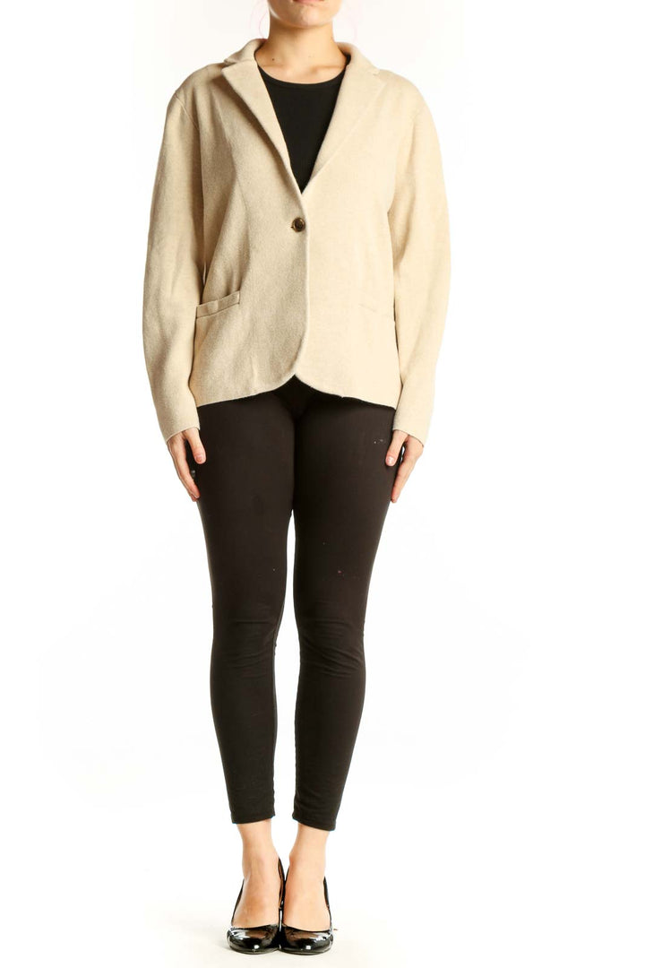 Front view of cream cotton knit blazer by J.Crew with single-button closure and front pockets, worn over black top